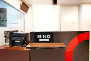 a hotel sign sitting on top of a kitchen counter at Super Hotel O Katol Road Friends Colony in Nagpur