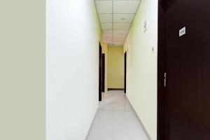 an empty hallway in an office building with a long corridor at Collection O Ganeshguri Nayanpur Formerly Rainbow Residency in Guwahati