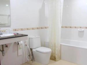 a white bathroom with a toilet and a sink at Neptuna Kata Beach in Kata Beach +31 photos