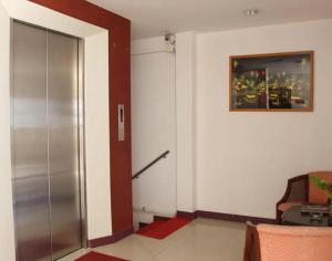 a room with a elevator and a door with a chair at Neptuna Kata Beach in Kata Beach