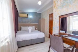 a bedroom with a bed and a desk and a desk at Oldcity aparts in Istanbul
