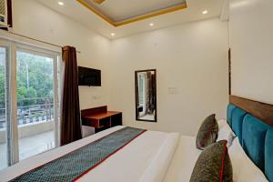 a hotel room with a bed and a window at Super Collection O Sector 55 Noida Near Noida Stadium in Noida