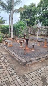 a park with a bench and a table and benches at Apartamento Doce Alegria in Sao Jose do Rio Preto