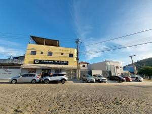 a group of cars parked in front of a building at Pousada Itaguaçu in Aparecida