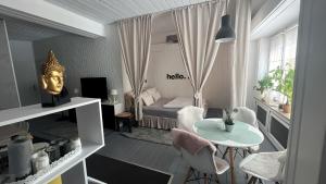 a small room with a bed and a table and chairs at Daheim in Essen in Essen