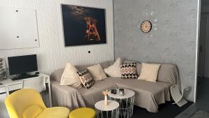 a living room with a couch and a clock on the wall at Daheim in Essen in Essen