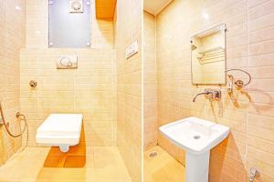 a bathroom with a toilet and a sink at Collection O Tilak Nagar Near Pacific Mall in New Delhi