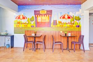 a restaurant with two tables and chairs and a gas station at Townhouse Amanora Park Town Formerly Samrat Inn in Pune