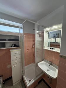 a bathroom with a shower and a sink at Nautic 108 in Cuxhaven +10 photos