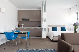 a kitchen and a bedroom with a bed and a table and chairs at Zambala Luxury Apartments in Milan