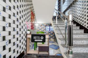 a lobby of a hotel with stairs and a sign at Hotel O Kakdwip in Kākdwīp
