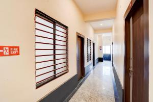 a hallway with a window in a building at Super Collection O Salori in Prayagraj