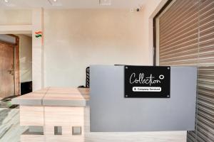 a refrigerator with a sign on it in a room at Super Collection O Salori in Prayagraj