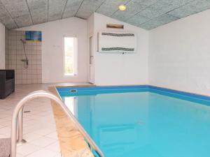 a large swimming pool in a bathroom with a tub at 6 person holiday home in Oksbøl-By Traum in Oksbøl