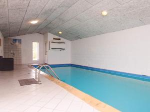 an empty swimming pool in a gym with a swimming pool at 6 person holiday home in Oksbøl-By Traum in Oksbøl