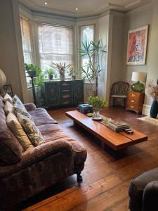 a living room with a couch and a coffee table at Central Boutique Townhouse in London