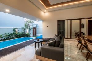 a living room with a couch and a swimming pool at Villa Sakura ll seminyak in Seminyak