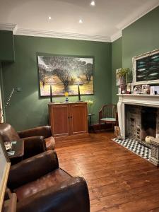 a living room with a couch and a fireplace at Central Boutique Townhouse in London