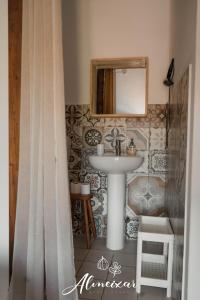 a bathroom with a sink and a mirror at Guest House Almeixar in Almancil +55 photos