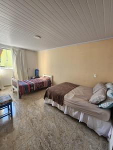 En eller flere senge i et værelse på Tranquilidade Absoluta Perto do Mar e Shopping + 18 billeder