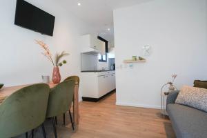 a living room with a table and chairs and a kitchen at De Texelaar in Elspeet