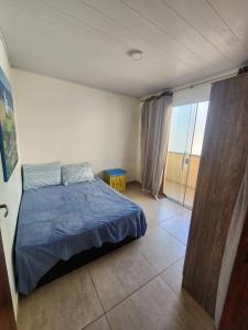 En eller flere senge i et værelse på Tranquilidade Absoluta Perto do Mar e Shopping