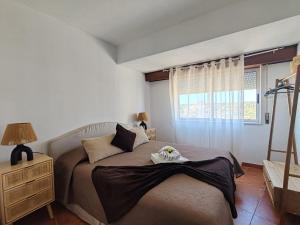 a bedroom with a bed and a window at 11A Rocha - Casas & Papeis in Armação de Pêra +57 photos