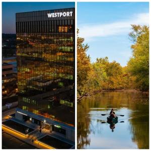 a building and a person in a boat in a river at Blue Boho Music and Meme House Four Bedroom Home with Arcade near Westport Plaza in Maryland Heights