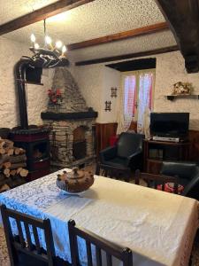 a living room with a table with a fireplace at Casa vacanze Fenera in Valduggia
