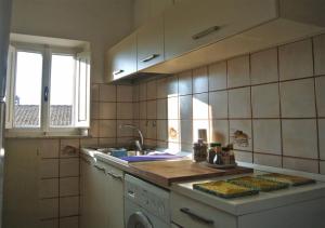 a kitchen with a sink and a counter top at Casa Lino in Volterra