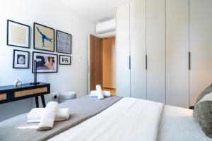a bedroom with a large white bed and a desk at Densho 2-Bedroom Luxury Apartment in Larnaka