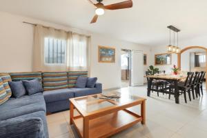 a living room with a blue couch and a table at La Lajita Beach House in La Lajita +26 photos