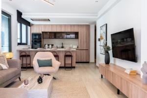 a living room with a couch and a table at Densho 2-Bedroom Luxury Apartment in Larnaka