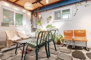 eine Gruppe von Stühlen und ein Tisch auf einer Terrasse in der Unterkunft 서울 성북 D'enough House in Seoul