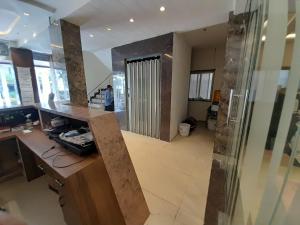 a room with a lobby with a counter and a door at Hotel Wizard Palace in Aurangabad