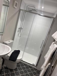 a bathroom with a shower with a toilet and a sink at The Anchor Inn in Sutton Bridge +49 photos