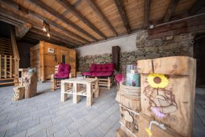 a room with a table and chairs and a stone wall at Waldviertel Auszeit - Lichtung im Wald - Alleinlage in Scheiben +57 photos
