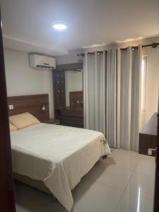 a bedroom with a large bed and a mirror at Condominio Irala in Santa Cruz de la Sierra