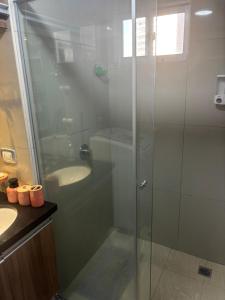 a bathroom with a glass shower and a sink at Condominio Irala in Santa Cruz de la Sierra