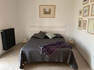 a bedroom with a bed with a purple blanket on it at Casa Di Poeta in Casacalenda