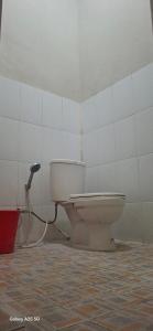 a bathroom with a toilet in a room at sahati homestay and swimingpool in Payakumbuh