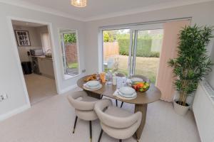 a kitchen and dining room with a table and chairs at The Serenity Cove in Solihull