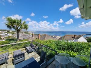 a balcony with chairs and a view of the ocean at 3 Bed in Newlyn oc-s33015 in Newlyn