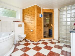 a bathroom with a tub and a toilet and a shower at 8 person holiday home in Ørsted-By Traum in Kare