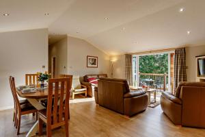 a living room with a table and a dining room at 3 Bed in Two Waters Foot oc-m27335 in Cardinham