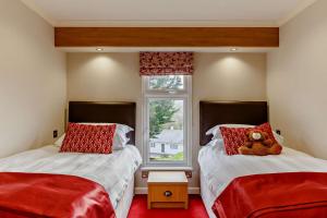 a bedroom with two beds with a teddy bear on them at 3 Bed in Two Waters Foot oc-m27335 in Cardinham