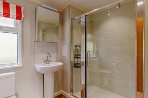 a bathroom with a glass shower and a sink at 3 Bed in Two Waters Foot oc-m27335 in Cardinham