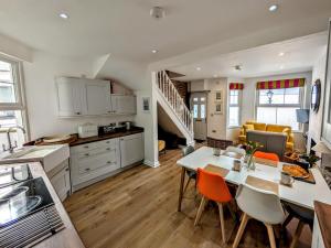 a kitchen and living room with a table and chairs at 3 Bed in Fowey oc-g33050 in Fowey