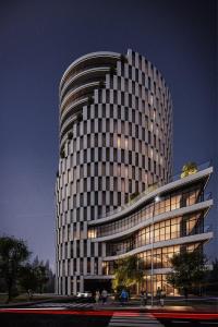 ドゥラスにあるCrowne Plaza Durres by IHGの夜間に窓がたくさんある高層ビル