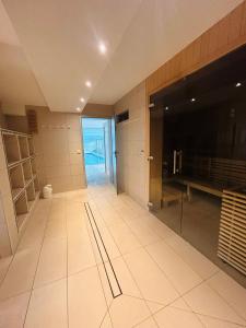 a large kitchen with white tile floors and a large window at Nautic 108 in Cuxhaven